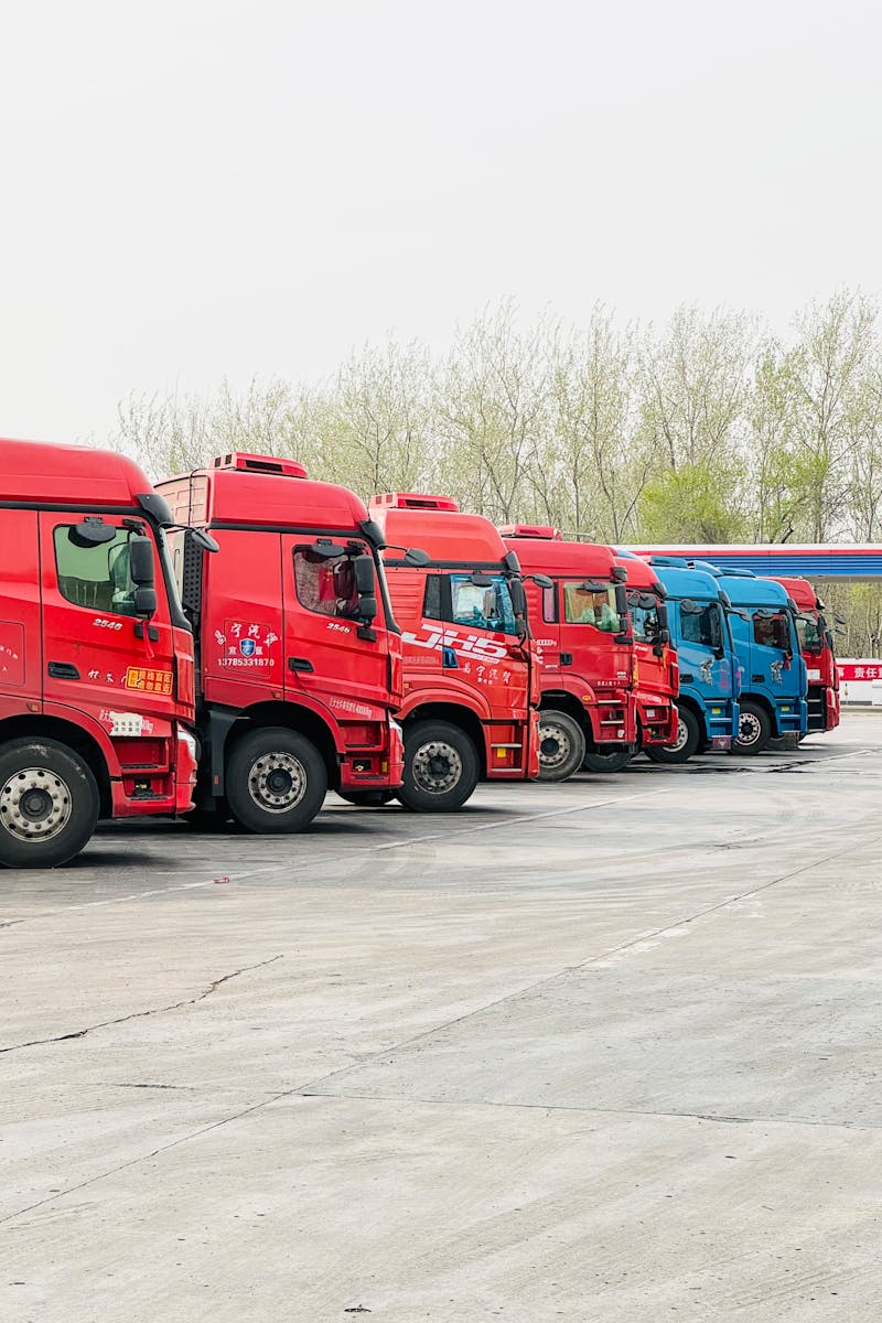A row of vibrant trucks parked at a transportation depot in Tianjin, China.